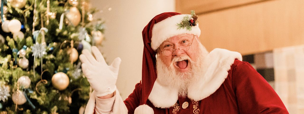 Santa waiving near a tree at The Junto